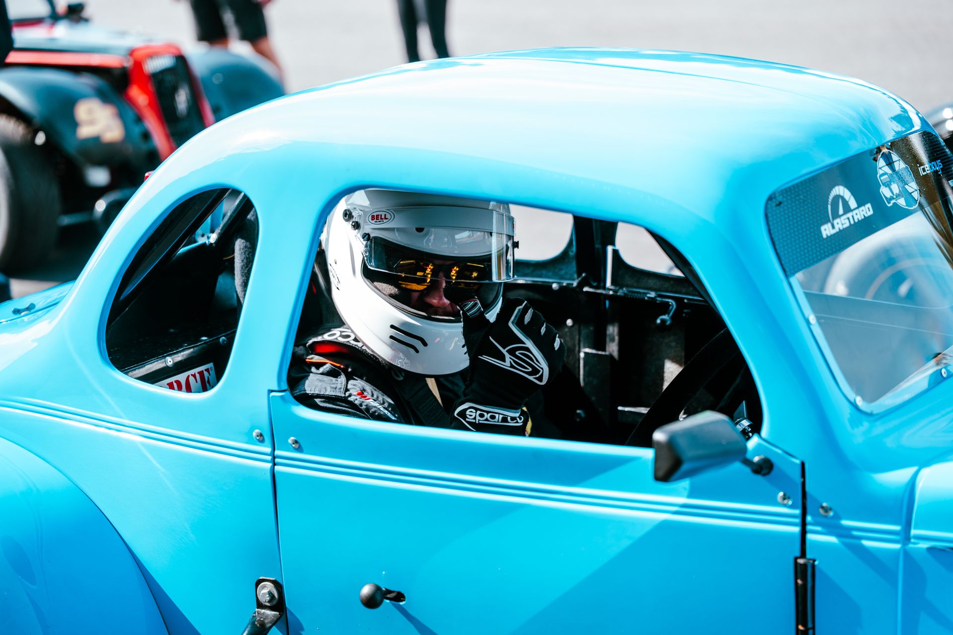 A guest at the wheel of a light-blue Legend car