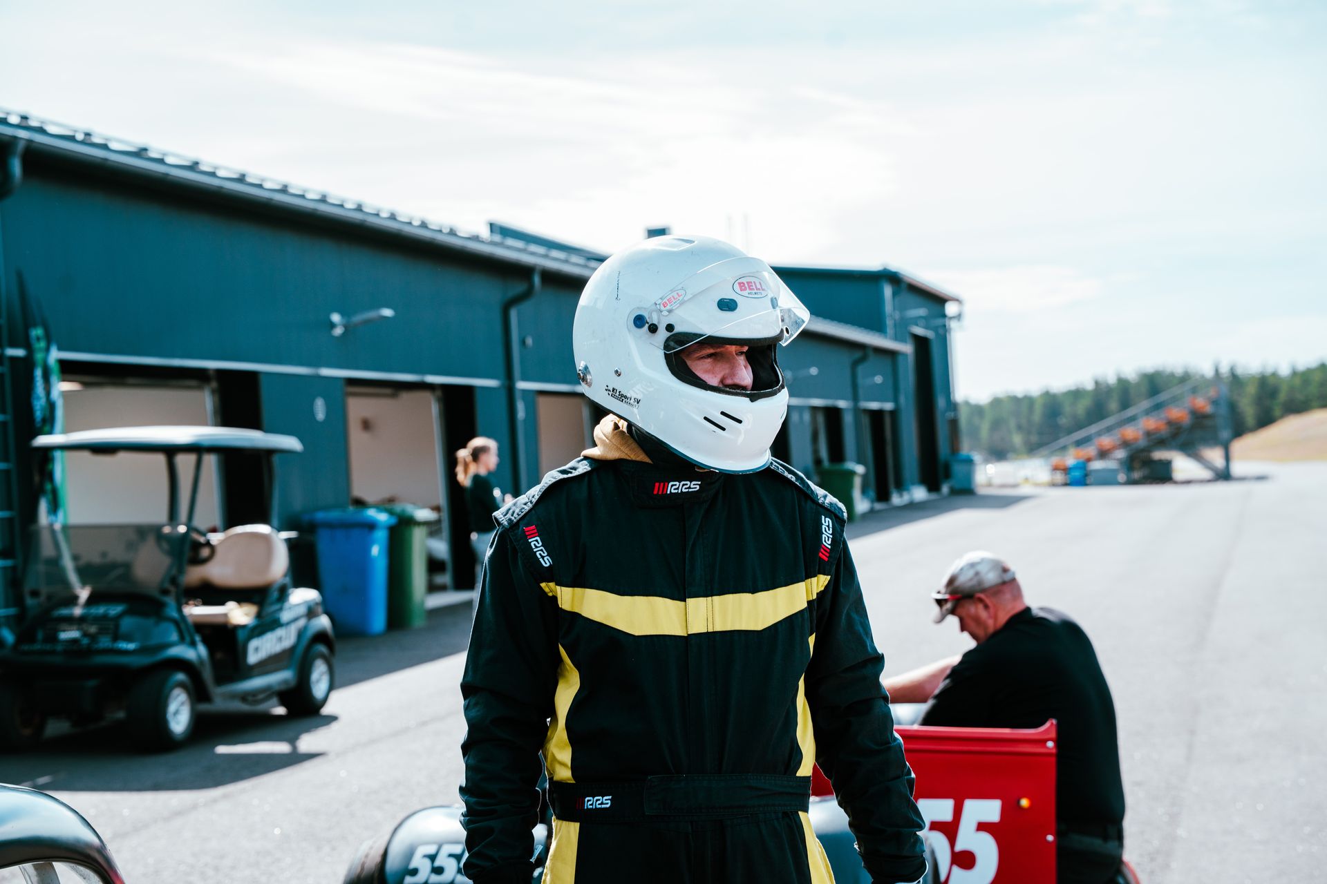 A guest suited and helmeted before a track session