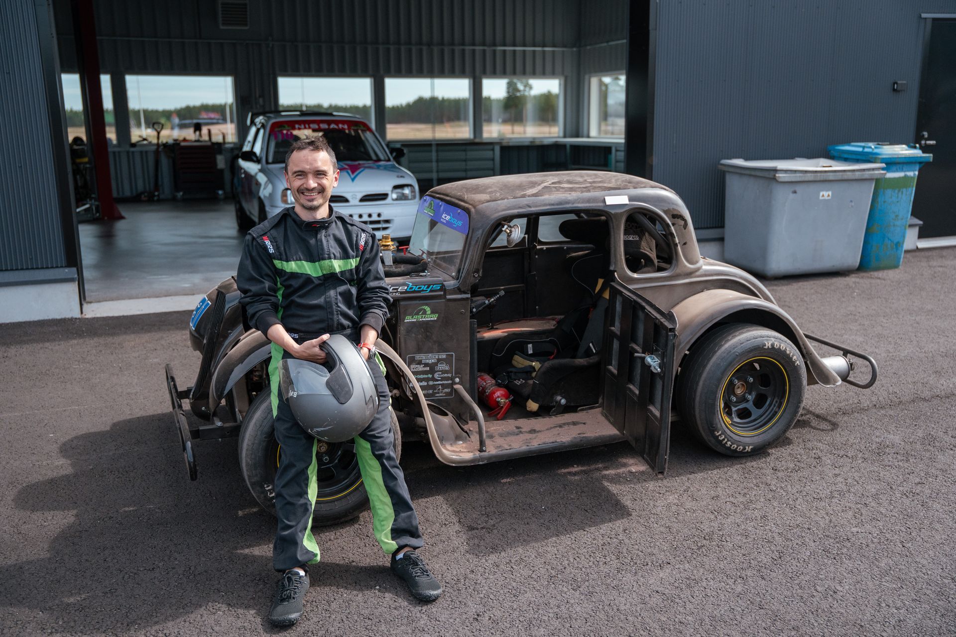 A guest sitting on a bare Legend car chassis